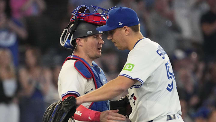 Jun 5, 2025; Toronto, Ontario, CAN; Toronto Blue Jays catcher Tyler Heineman (55) and pitcher Erik Swanson (50) celebrate a win over the Philadelphia Phillies at Rogers Centre. Mandatory Credit: John E. Sokolowski-Imagn Images