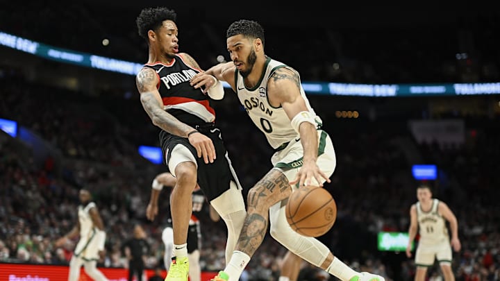 Mar 11, 2024; Portland, Oregon, USA; Boston Celtics forward Jayson Tatum (0) drives to the basket during the second half against Portland Trail Blazers guard Anfernee Simons (1) at Moda Center. Mandatory Credit: Troy Wayrynen-Imagn Images