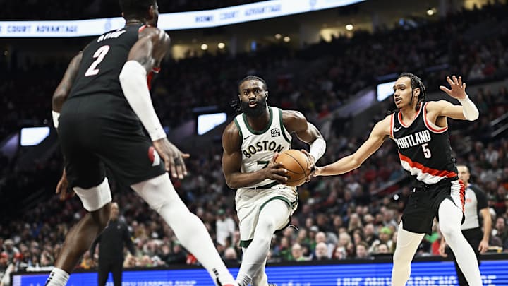 Mar 11, 2024; Portland, Oregon, USA; Boston Celtics guard Jaylen Brown (7) drives to the basket during the first half against Portland Trail Blazers guard Dalano Banton (5) and center Deandre Ayton (2) at Moda Center. Mandatory Credit: Troy Wayrynen-Imagn Images