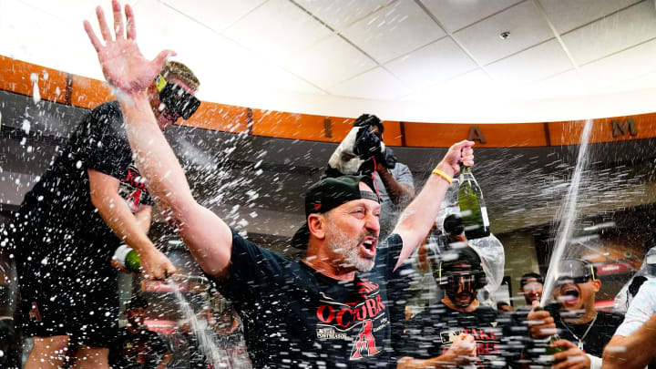 Arizona Diamondbacks manager Torey Lovullo is sprayed with champagne during celebrations after clinching a wild-card playoff spot following their game with the Houston Astros at Chase Field on Sep 30, 2023.