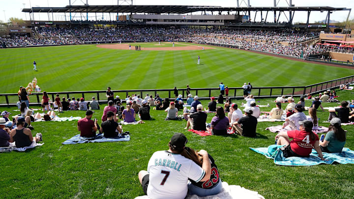 Fans watch the action from the left field lawn as the Arizona Diamondbacks play the Colorado Rockies during the first spring training game at Salt River Fields on Feb. 23, 2024. Fans watch the action from the left field lawn as the Arizona Diamondbacks play the Colorado Rockies during the first spring training game at Salt River Fields on Feb. 23, 2024.