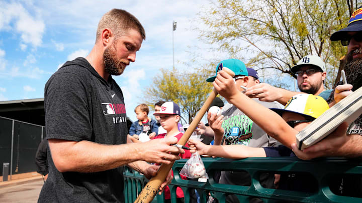 Arizona Diamondbacks pitcher Merrill Kelly signs autographs during spring training workouts at Salt River Fields at Talking Stick on Feb. 12, 2025, in Scottsdale.