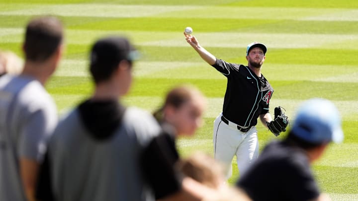Arizona Diamondbacks pitcher Merrill Kelly warms up his arm before facing the Kansas City Royals during a spring training game at Salt River Fields at Talking Stick on March 11, 2025. Arizona Diamondbacks pitcher Merrill Kelly warms up his arm before facing the Kansas City Royals during a spring training game at Salt River Fields at Talking Stick on March 11, 2025.