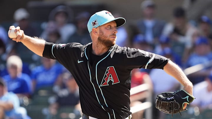 Arizona Diamondbacks starting pitcher Merrill Kelly throws to the Kansas City Royals in the third inning during a spring training game at Salt River Fields at Talking Stick on March 11, 2025.