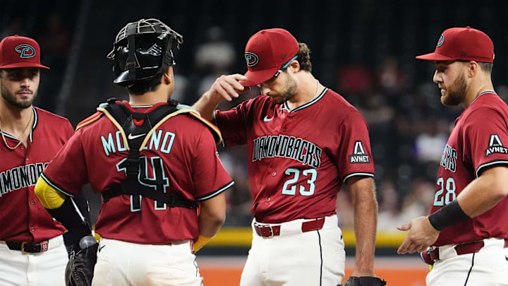 Arizona Diamondbacks pitcher Zac Gallen (23) reacts during a mound visit from the pitcher coach against the Texas Rangers in the fifth inning at Chase Field on Sept. 3, 2025.