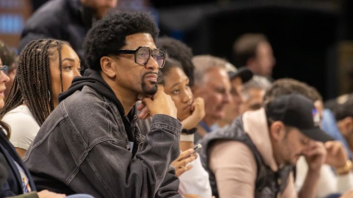 Oct 30, 2022; Detroit, Michigan, USA; Former NBA and University of Michigan  Fab Five  player Jalen Rose has a front row seat for the game between the Detroit Pistons and the Golden State Warriors during the in the first half at Little Caesars Arena. Mandatory Credit: David Reginek-Imagn Images