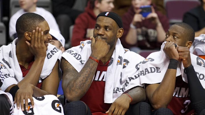 Feb 11, 2011; Auburn Hills, MI, USA; Miami Heat power forward Chris Bosh (left), small forward LeBron James (center), and shooting guard Dwyane Wade (3) sit on the bench in the fourth quarter of an NBA game at The Palace. Miami defeated Detroit 106-92. Mandatory Credit: Rick Osentoski-Imagn Images