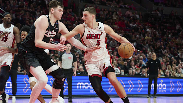 Jan 11, 2025; Portland, Oregon, USA; Miami Heat forward Nikola Jovic (5) drives to the basket during the second half against against Portland Trail Blazers center Donovan Clingan (23) at Moda Center. Mandatory Credit: Troy Wayrynen-Imagn Images