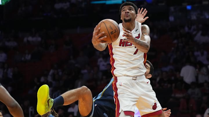 Oct 17, 2025; Miami, Florida, USA;  Miami Heat center Kel'El Ware (7) gets fouled by Memphis Grizzlies forward/center Santi Aldama (7) during the first half at Kaseya Center. Mandatory Credit: Jim Rassol-Imagn Images
