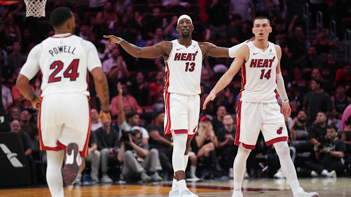 Dec 1, 2025; Miami, Florida, USA; Miami Heat center Bam Adebayo (13), guard Norman Powell (24) and guard Tyler Herro (14) get back on defense against the Los Angeles Clippers during the second half at Kaseya Center. Mandatory Credit: Jim Rassol-Imagn Images