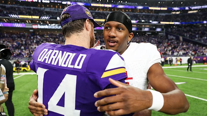 Vikings quarterback Sam Darnold and the Falcons' Michael Penix Jr., the former Trojan and Husky, embrace after their recent game. 