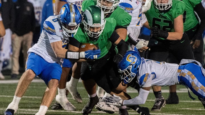 Junipero Serra’s Jeovanni Henley, right, and Dylan Modena bring down a St. Mary’s player in the playoffs. 