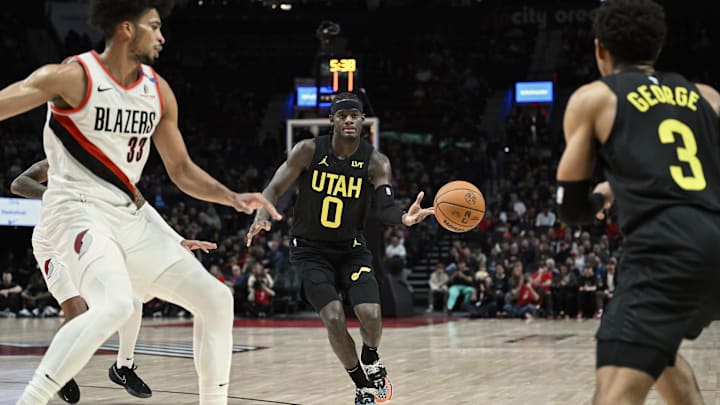 Oct 18, 2024; Portland, Oregon, USA; Utah Jazz forward Taylor Hendricks (0) passes the ball to teammate guard Keyonte George (3) during the first half against Portland Trail Blazers forward Toumani Camara (33) at Moda Center. Mandatory Credit: Troy Wayrynen-Imagn Images Oct 18, 2024; Portland, Oregon, USA; Utah Jazz forward Taylor Hendricks (0) passes the ball to teammate guard Keyonte George (3) during the first half against Portland Trail Blazers forward Toumani Camara (33) at Moda Center. Mandatory Credit: Troy Wayrynen-Imagn Images