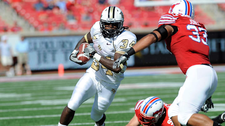Oct 15, 2011; Dallas, TX, USA; UCF Knights running back Brynn Harvey (34) runs around the end against the Southern Methodist Mustangs during the first quarter at Gerald J. Ford Stadium. Mandatory Credit: Jerome Miron-Imagn Images Oct 15, 2011; Dallas, TX, USA; UCF Knights running back Brynn Harvey (34) runs around the end against the Southern Methodist Mustangs during the first quarter at Gerald J. Ford Stadium. Mandatory Credit: Jerome Miron-Imagn Images
