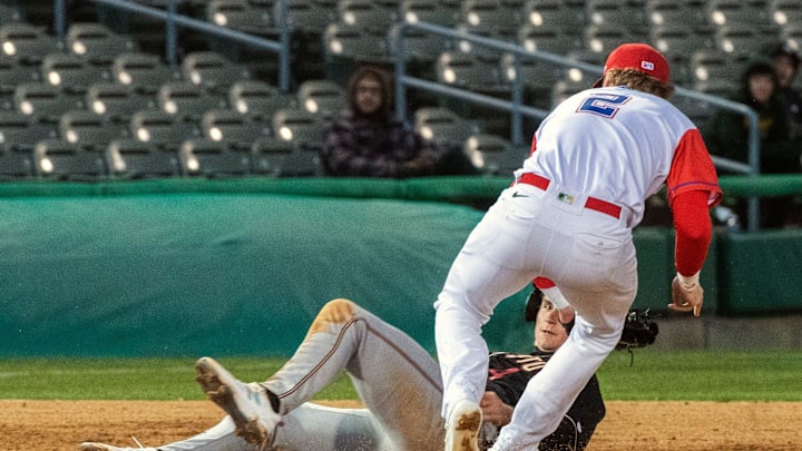 Stockton Ports' Bjay Cooke, right, tags Modesto Nuts' Colt Emerson at the end of a rundown during the Ports' home opener at the Stockton Ballpark in downtown Stockton on Apr. 5, 2024.
