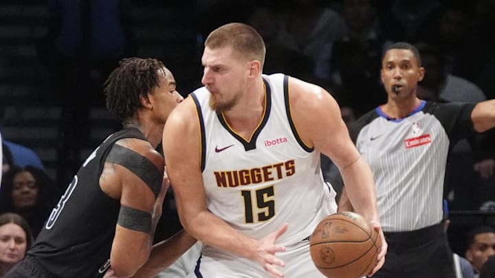Denver Nuggets center Nikola Jokic (15) looks to make a move on Brooklyn Nets center Nic Claxton (33) during the second half at Barclays Center. Mandatory Credit: Gregory Fisher-Imagn Images