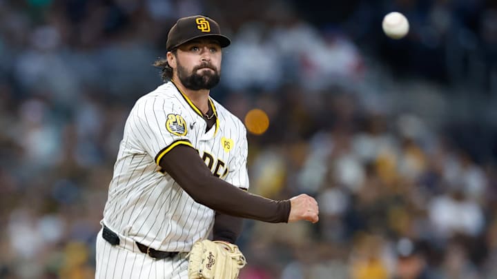 May 28, 2024; San Diego, California, USA; San Diego Padres starting pitcher Matt Waldron (61) attempts to pick off a runner at first during the fifth inning against the Miami Marlins at Petco Park. Mandatory Credit: David Frerker-USA TODAY Sports