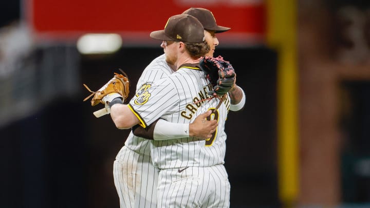 Jul 31, 2024; San Diego, California, USA; San Diego Padres third baseman Manny Machado (13) hugs first baseman Jake Cronenworth (9) after the final out against the Los Angeles Dodgers at Petco Park. Mandatory Credit: David Frerker-USA TODAY Sports
