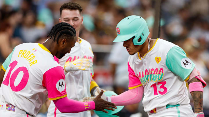 Sep 6, 2024; San Diego, California, USA; San Diego Padres third basemen Manny Machado (13) celebrates with San Diego Padres left fielder Jurickson Profar (10) after hitting a one run home run during the first inning against the San Francisco Giants  at Petco Park. Mandatory Credit: David Frerker-Imagn Images