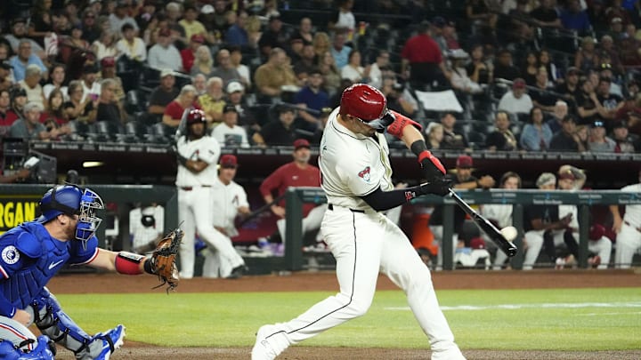Arizona Diamondbacks Randal Grichuk (15) hits a two-run home run against the Texas Rangers in the first inning at Chase Field in Phoenix on Sept. 11, 2024.