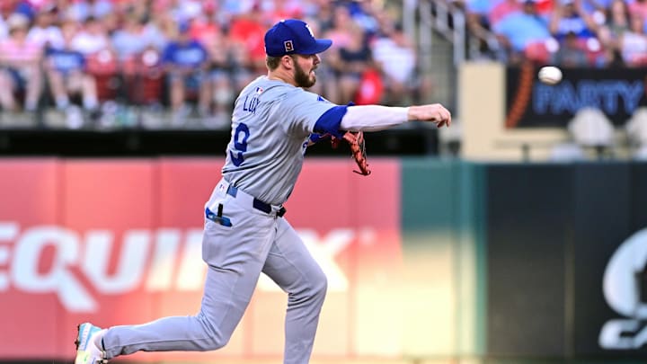 Aug 17, 2024; St. Louis, Missouri, USA; Los Angeles Dodgers second base Gavin Lux (9) throws to first base for a double play on St. Louis Cardinals players Lars Nootbaar and Paul Goldschmidt (not shown) in the second inning at Busch Stadium. Mandatory Credit: Tim Vizer-Imagn Images