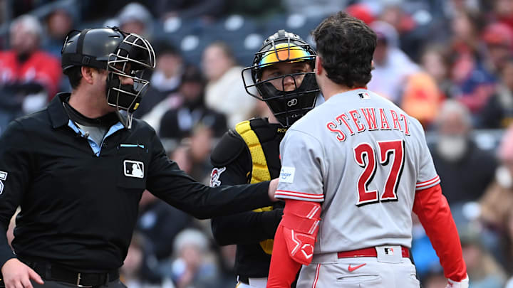 May 2, 2026; Pittsburgh, Pennsylvania, USA;  Home plate umpire Willie Traynow keeps Cincinnati Reds second baseman Sal Stewart (27) away from Pittsburgh Pirates cvatcher Henry Davis after he was nearly hit by the ball during the seventh inning at PNC Park. Mandatory Credit: Philip G. Pavely-Imagn Images
