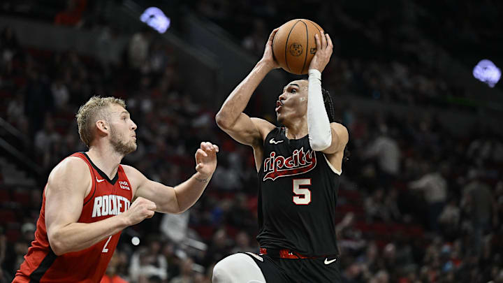 Apr 12, 2024; Portland, Oregon, USA; Portland Trail Blazers guard Dalano Banton (5) drives to the basket during the second half against Houston Rockets center Jock Landale (2) at Moda Center. Mandatory Credit: Troy Wayrynen-Imagn Images