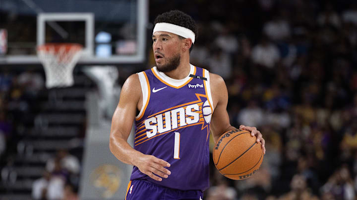 Oct 6, 2024; Palm Desert, California, USA; Phoenix Suns guard Devin Booker (1) moves the ball against the Los Angeles Lakers during the first half at Acrisure Arena. Mandatory Credit: David Frerker-Imagn Images