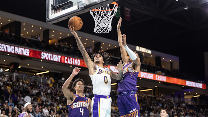 Oct 6, 2024; Palm Desert, California, USA; Los Angeles Lakers guard Jalen Hood-Schifino (0) shoots a layup against the Phoenix Suns during the second half at Acrisure Arena. Mandatory Credit: David Frerker-Imagn Images