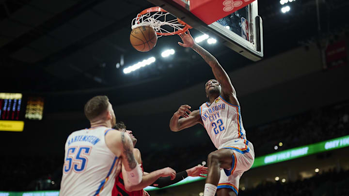Jan 26, 2025; Portland, Oregon, USA; Oklahoma City Thunder guard Cason Wallace (22) dunks the basketball during the first half against Portland Trail Blazers forward Deni Avdija (8) at Moda Center. Mandatory Credit: Troy Wayrynen-Imagn Images