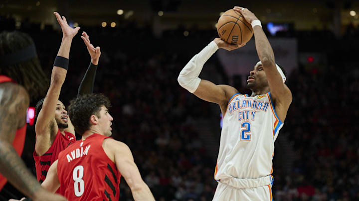 Jan 26, 2025; Portland, Oregon, USA; Oklahoma City Thunder guard Shai Gilgeous-Alexander (2) shoots a jump shot during the second half against Portland Trail Blazers forward Deni Avdija (8) and forward Toumani Camara (33) at Moda Center. Mandatory Credit: Troy Wayrynen-Imagn Images