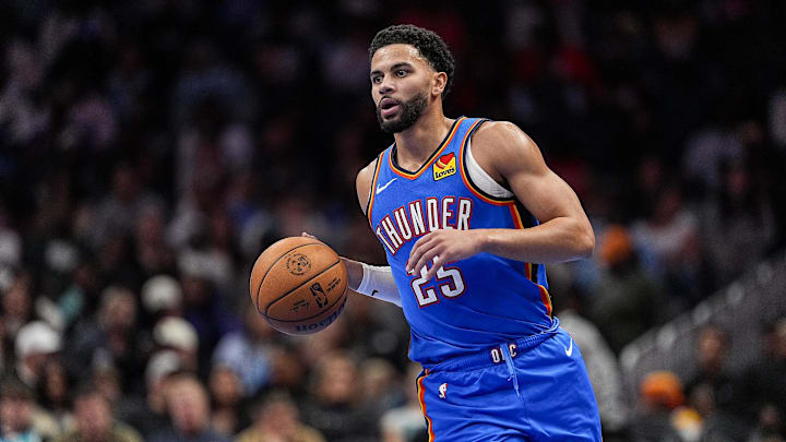 Nov 15, 2025; Charlotte, North Carolina, USA; Oklahoma City Thunder guard Ajay Mitchell (25) brings the ball up court against the Charlotte Hornets during the second half at Spectrum Center. Mandatory Credit: Jim Dedmon-Imagn Images