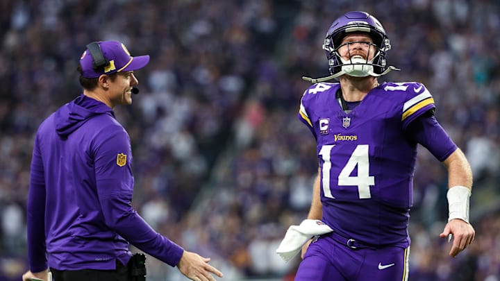 Dec 8, 2024; Minneapolis, Minnesota, USA; Minnesota Vikings quarterback Sam Darnold (14) celebrates running back Aaron Jones' (33) touchdown run with head coach Kevin O'Connell during the fourth quarter against the Atlanta Falcons at U.S. Bank Stadium.