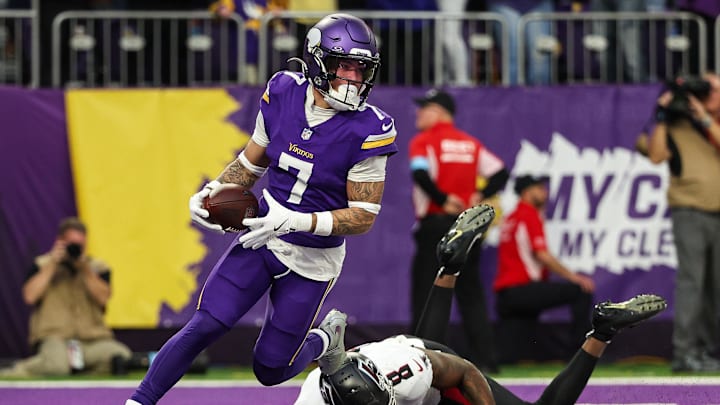 Dec 8, 2024; Minneapolis, Minnesota, USA; Minnesota Vikings cornerback Byron Murphy Jr. (7) intercepts a pass intended for Atlanta Falcons tight end Kyle Pitts (8) during the fourth quarter at U.S. Bank Stadium. Mandatory Credit: Matt Krohn-Imagn Images