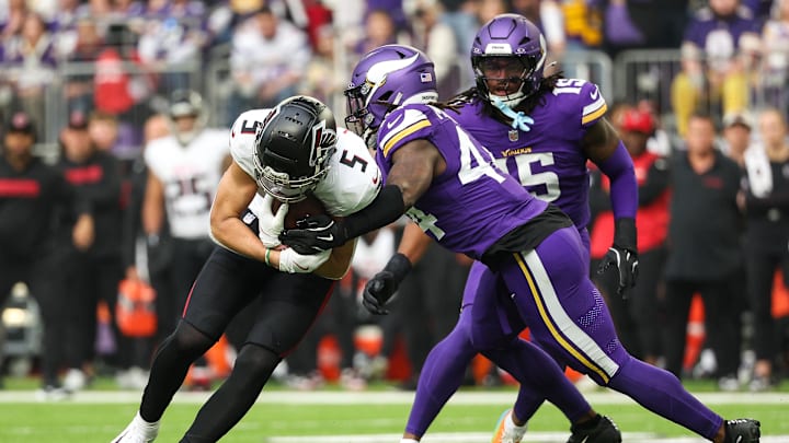 Dec 8, 2024; Minneapolis, Minnesota, USA; Atlanta Falcons wide receiver Drake London (5) runs after the catch as Minnesota Vikings safety Josh Metellus (44) defends during the first quarter at U.S. Bank Stadium.