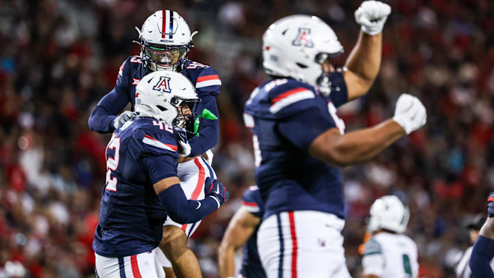 Aug 30, 2025; Tucson, Arizona, USA; Arizona Wildcats defensive lineman Dominic Lolesio (42) and defensive back Dalton Johnson (43) both celebrate a tackle made during the third quarter of the game against the Hawaii Rainbow Warriors at Arizona Stadium. Mandatory Credit: Aryanna Frank-Imagn Images