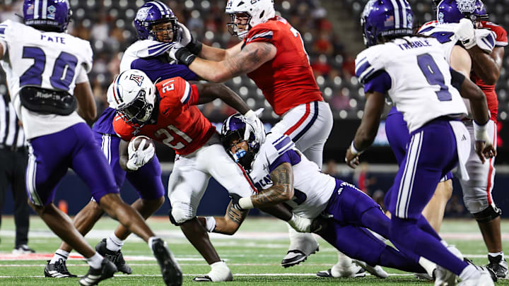 Sep 6, 2025; Tucson, Arizona, USA; Weber State Wildcats linebacker Sione Hala (13) tackles Arizona Wildcats running back Ismail Mahdi (21) during the third quarter of the game at Arizona Stadium. Mandatory Credit: Aryanna Frank-Imagn Images Sep 6, 2025; Tucson, Arizona, USA; Weber State Wildcats linebacker Sione Hala (13) tackles Arizona Wildcats running back Ismail Mahdi (21) during the third quarter of the game at Arizona Stadium. Mandatory Credit: Aryanna Frank-Imagn Images