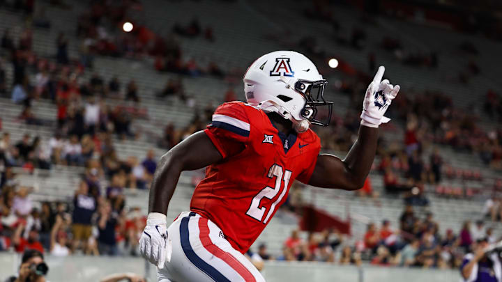 Sep 6, 2025; Tucson, Arizona, USA; Arizona Wildcats defensive back Johno Price (21) points up after intercepting the ball and scoring a touchdown during the third quarter of the game against the Weber State Wildcats at Arizona Stadium. Mandatory Credit: Aryanna Frank-Imagn Images