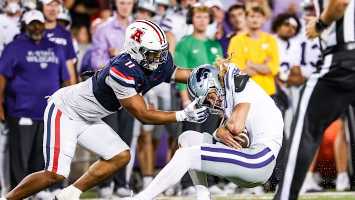 Sep 12, 2025; Tucson, Arizona, USA; Arizona Wildcats linebacker Jabari Mann (11) tackles Kansas State Wildcats quarterback Avery Johnson (2) during the fourth quarter of the game at Arizona Stadium. Mandatory Credit: Aryanna Frank-Imagn Images