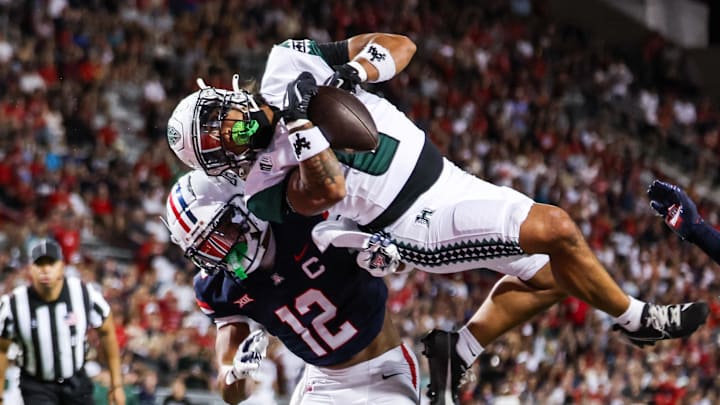 Aug 30, 2025; Tucson, Arizona, USA; Arizona Wildcats defensive back Genesis Smith (12) blocks Hawaii Rainbow Warriors running back Cam Barfield (0) from a touchdown catch during the first quarter at Arizona Stadium. Mandatory Credit: Aryanna Frank-Imagn Images Aug 30, 2025; Tucson, Arizona, USA; Arizona Wildcats defensive back Genesis Smith (12) blocks Hawaii Rainbow Warriors running back Cam Barfield (0) from a touchdown catch during the first quarter at Arizona Stadium. Mandatory Credit: Aryanna Frank-Imagn Images