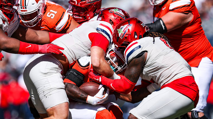 Oct 4, 2025; Tucson, Arizona, USA; Oklahoma State Cowboys gets tackled by the Arizona Wildcats during the third quarter of the game at Arizona Stadium. Mandatory Credit: Aryanna Frank-Imagn Images