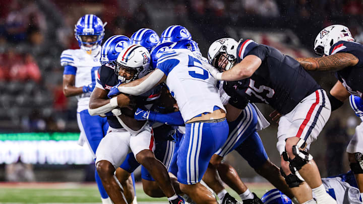 Oct 11, 2025; Tucson, Arizona, USA; Brigham Young Cougars attempts to tackle Arizona Wildcats running back Kedrick Reescano (3) during the second quarter of the game at Arizona Stadium. Mandatory Credit: Aryanna Frank-Imagn Images Oct 11, 2025; Tucson, Arizona, USA; Brigham Young Cougars attempts to tackle Arizona Wildcats running back Kedrick Reescano (3) during the second quarter of the game at Arizona Stadium. Mandatory Credit: Aryanna Frank-Imagn Images