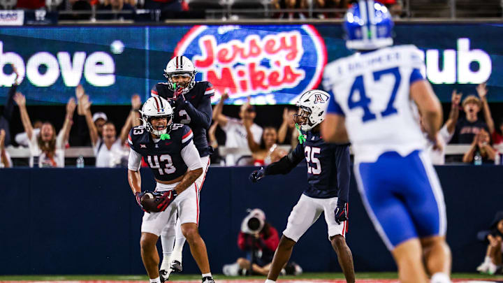 Oct 11, 2025; Tucson, Arizona, USA; Arizona Wildcats defensive back Dalton Johnson (43) celebrates an interception he caught from the Brigham Young Cougars with his team during the third quarter of the game at Arizona Stadium. Mandatory Credit: Aryanna Frank-Imagn Images Oct 11, 2025; Tucson, Arizona, USA; Arizona Wildcats defensive back Dalton Johnson (43) celebrates an interception he caught from the Brigham Young Cougars with his team during the third quarter of the game at Arizona Stadium. Mandatory Credit: Aryanna Frank-Imagn Images