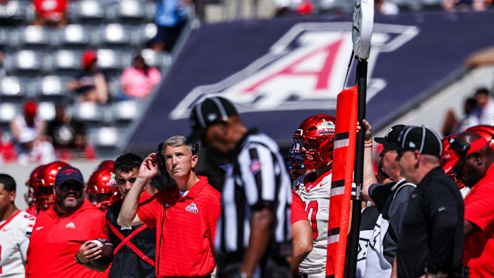 Oct 4, 2025; Tucson, Arizona, USA; Arizona Wildcats head coach Brent Brennan looks up at the scoreboard during the first quarter of the game against the Oklahoma State Cowboys at Arizona Stadium. Mandatory Credit: Aryanna Frank-Imagn Images Oct 4, 2025; Tucson, Arizona, USA; Arizona Wildcats head coach Brent Brennan looks up at the scoreboard during the first quarter of the game against the Oklahoma State Cowboys at Arizona Stadium. Mandatory Credit: Aryanna Frank-Imagn Images