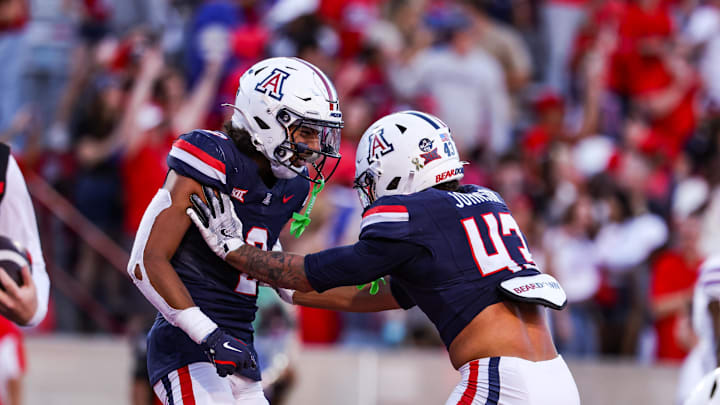Nov 8, 2025; Tucson, Arizona, USA; Arizona Wildcats defensive backs Treydan Stukes and Dalton Johnson celebrate a win against the Kansas Jayhawks at the end of the game at Arizona Stadium. Mandatory Credit: Aryanna Frank-Imagn Images