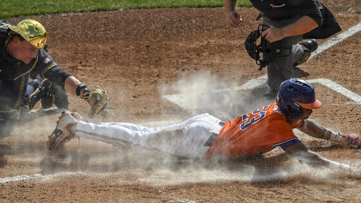 Mar 14, 2025; Clemson, SC, USA; Clemson sophomore Jarren Purify (23)  scores under a late tag by Notre Dame catcher Carson Tinney (8) during the bottom of the first inning at Doug Kingsmore Stadum in Clemson, S.C. Friday, March 14, 2025. Mandatory Credit: Ken Ruinard/USA TODAY Network via Imagn Images