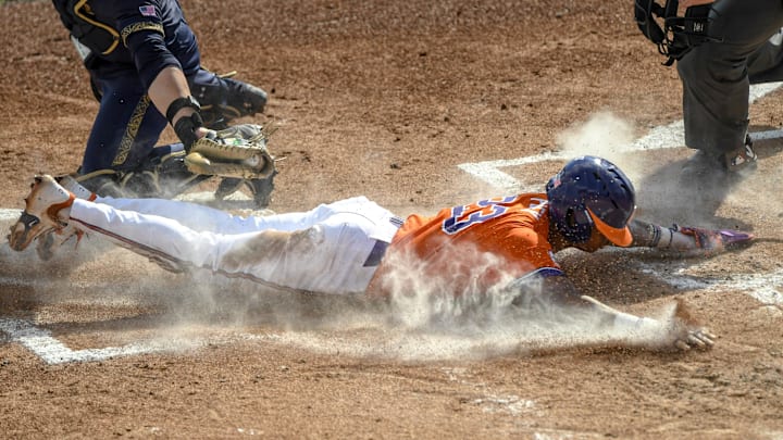 Mar 14, 2025; Clemson, SC, USA; Clemson sophomore Jarren Purify (23)  scores under a late tag by Notre Dame catcher Carson Tinney (8) during the bottom of the first inning at Doug Kingsmore Stadum in Clemson, S.C. Friday, March 14, 2025. Mandatory Credit: Ken Ruinard/USA TODAY Network via Imagn Images