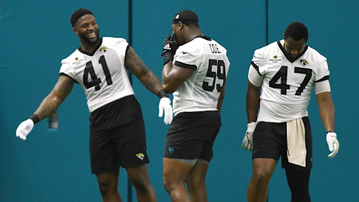 Jacksonville Jaguars linebacker Josh Allen (41) jokes with teammates linebacker Myles Cole (59) and defensive end De'Shaan Dixon (47) during a break between drills. The Jacksonville Jaguars let most of the veterans off from participating in Monday's mandatory minicamp session held in the air conditioned enclosed field at EverBank Stadium's Miller Electric Center in Jacksonville, Fla. June 10, 2024. [Bob Self/Florida Times-Union]