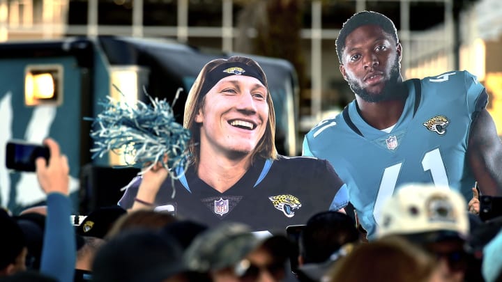Oversized photos of Jacksonville Jaguars quarterback Trevor Lawrence (16) and teammate linebacker Josh Allen (41) are carried behind the crowd as they waited for the team to leave the stadium Friday morning. Hundreds of Jacksonville Jaguar fans waited outside the West entrance of TIAA Bank Field Friday morning, January 20, 2023, to cheer on the team as they headed to their cars to drive to the airport for their flight to Kansas City to play their AFC divisional round game against the Chiefs on