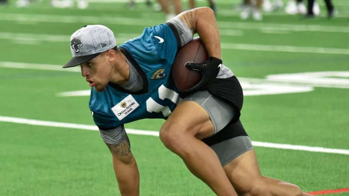 Jacksonville Jaguars wide receiver Parker Washington (11) turns to run down the sideline after pulling in a pass during drills. The Jacksonville Jaguars let most of the veterans off from participating in Monday's mandatory minicamp session held in the air conditioned enclosed field at EverBank Stadium's Miller Electric Center in Jacksonville, Fla. June 10, 2024. [Bob Self/Florida Times-Union]